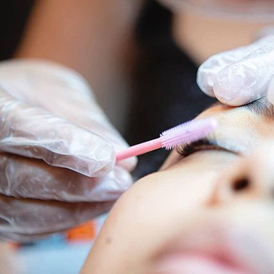 Woman receiving eyelash extensions.