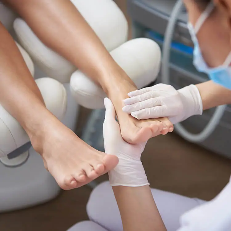Purlux pedicurist gently massaging woman leg after pedicure